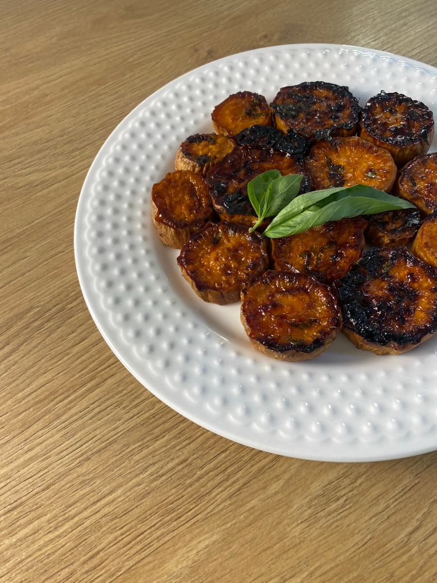 Golden fritters on a patterned white plate